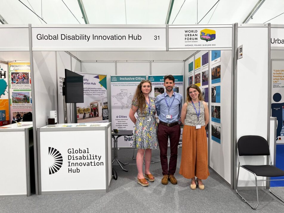 The 3 members of the Inclusive Design Team stand in front of the Expo Stand