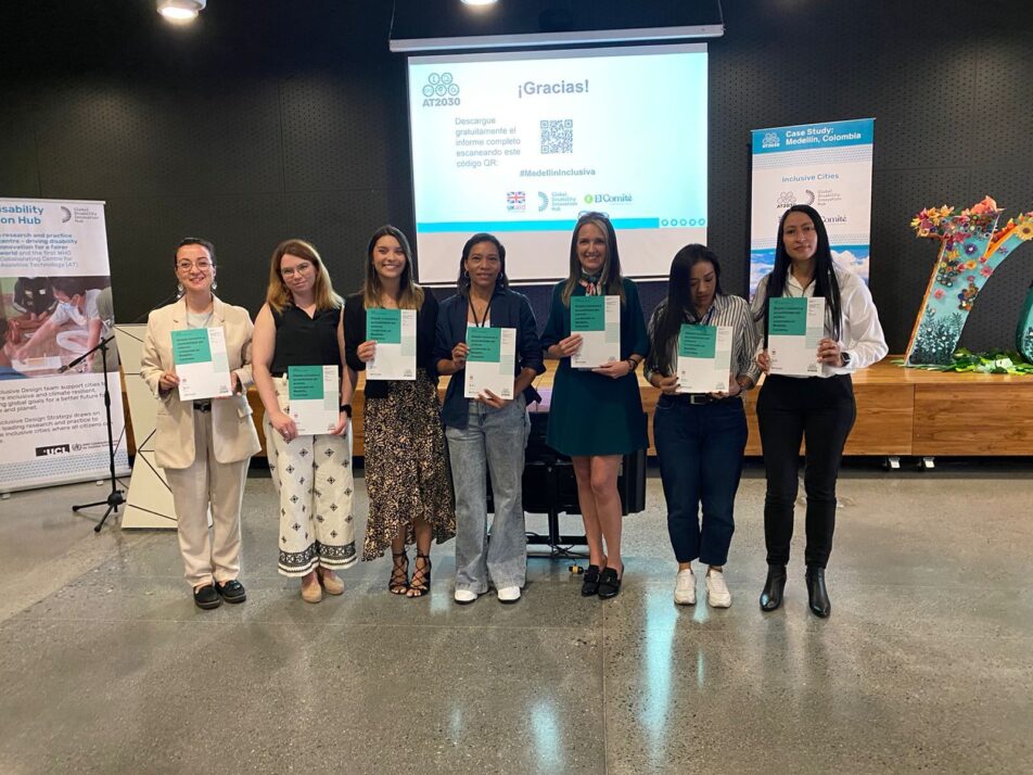 A group photo of seven participants holding the Inclusive infrastracture case studies launched reports in Medellin