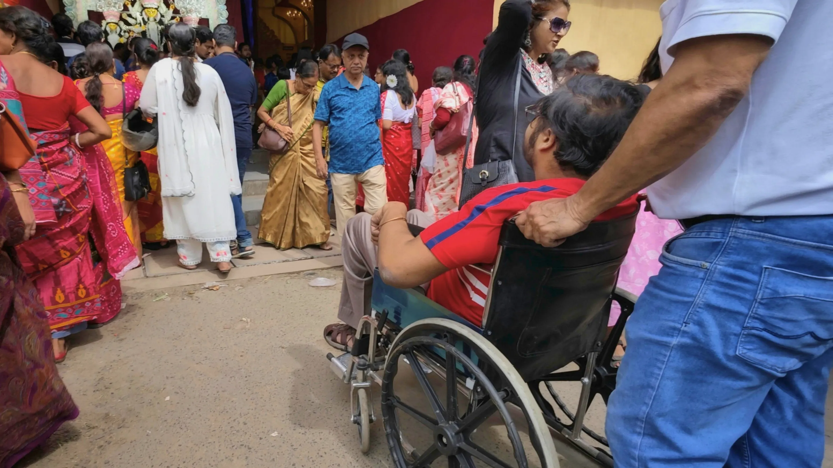 Person in wheelchair approaching place of worship in India