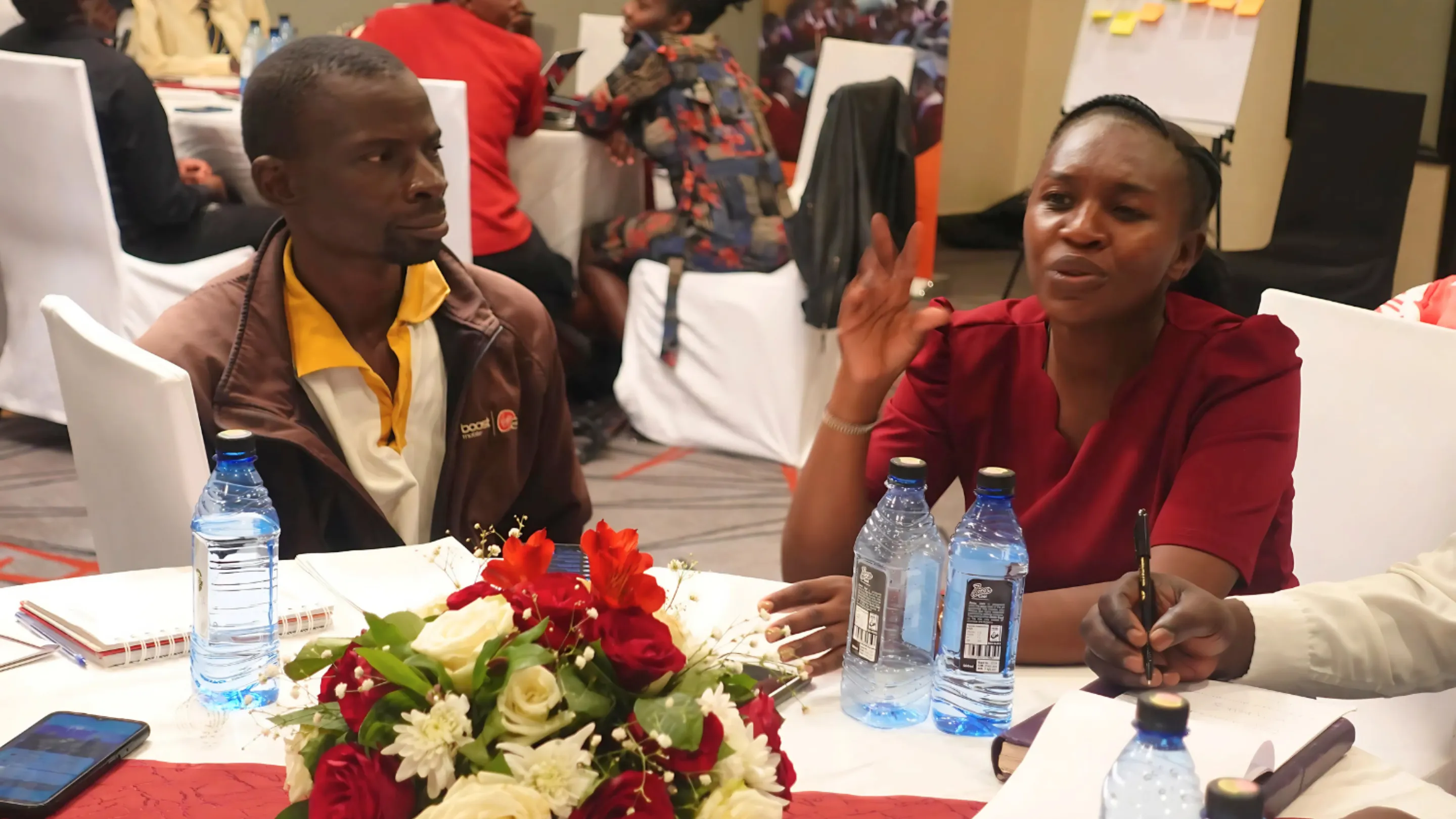 Two people talking at our OPD event in Kenya