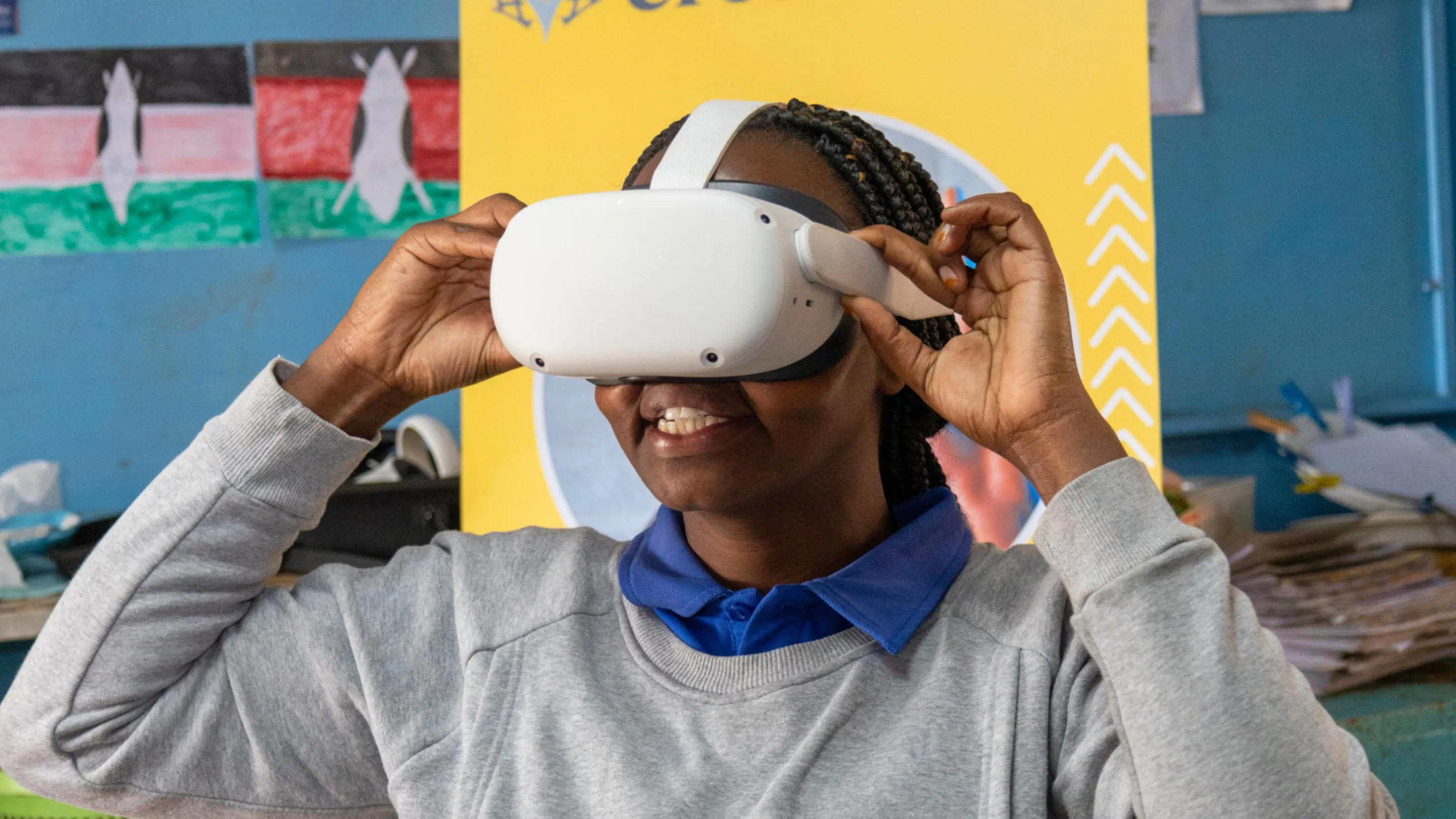 A person wearing a virtual reality headset adjusts it with their hands.