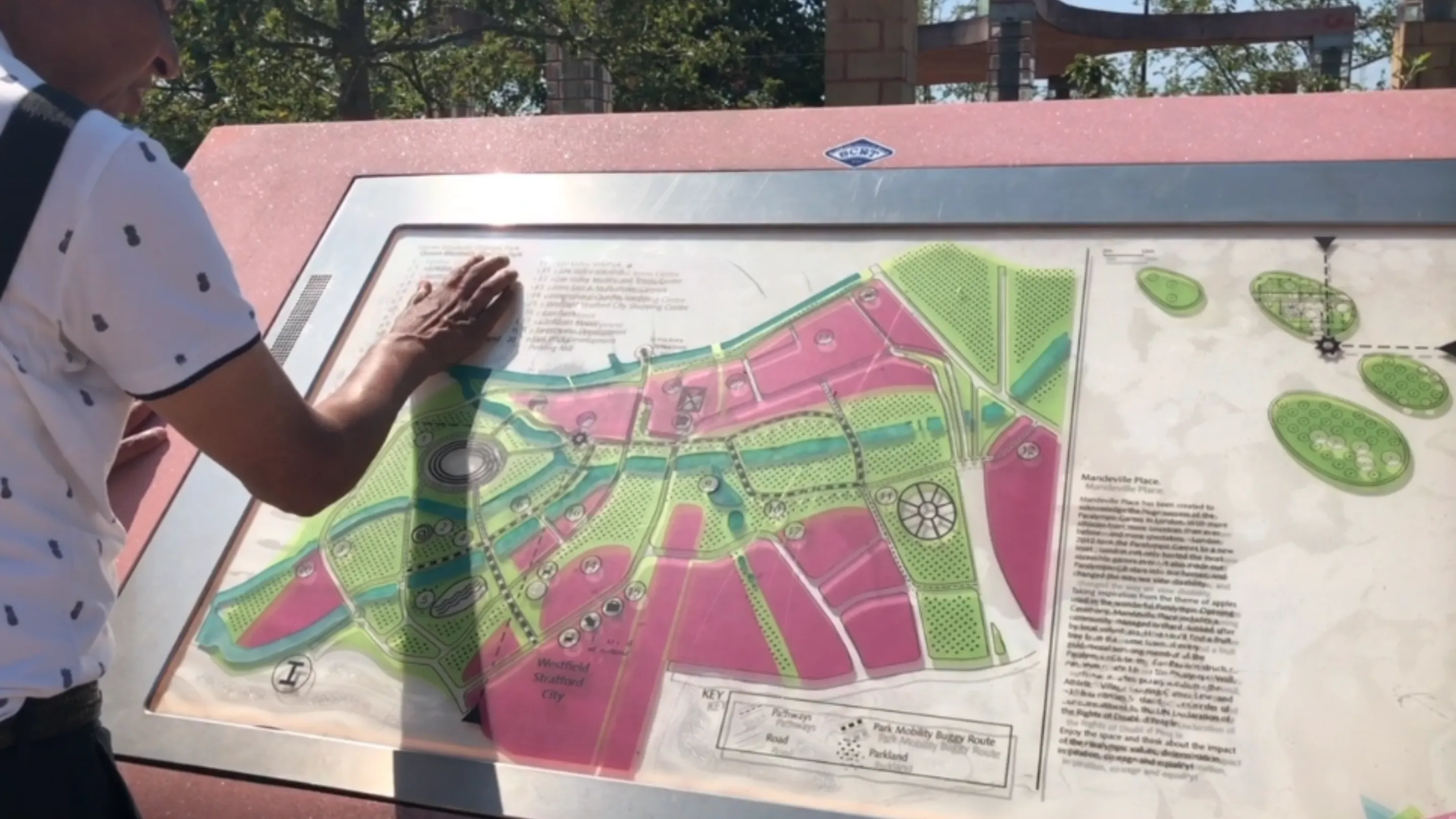A blind individual touching the Queen Elizabeth Olympic Park tactile map