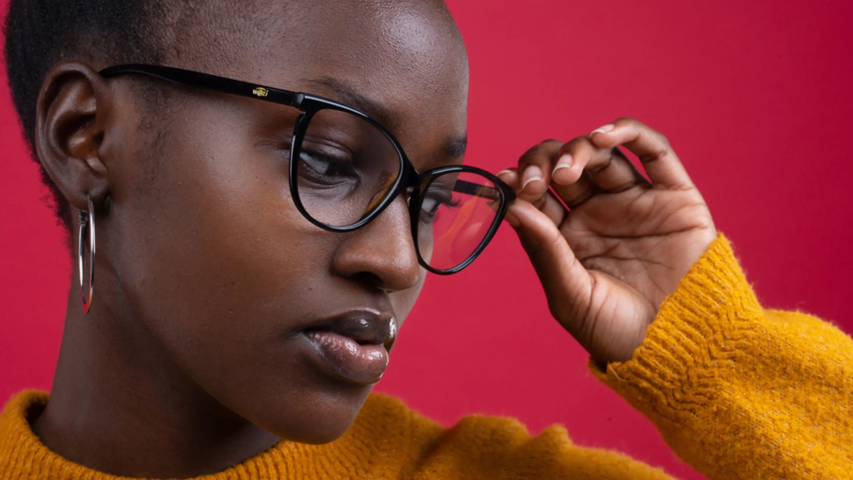 Image of young women - wearing fashion led eye glasses - in a bright jumper