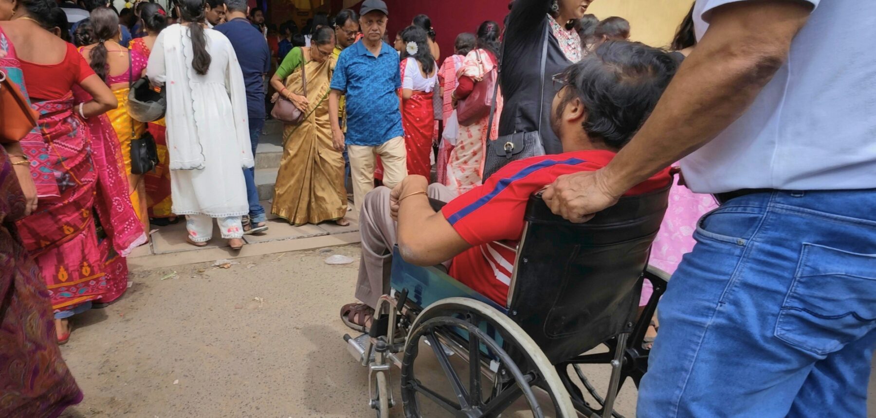 Person in wheelchair approaching place of worship in India
