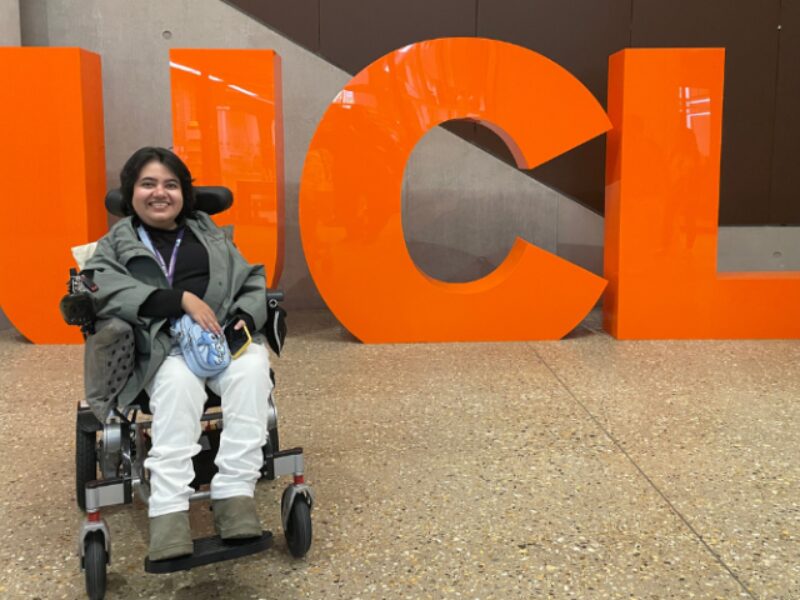 Kavya in front of UCL's logo at Marshagate