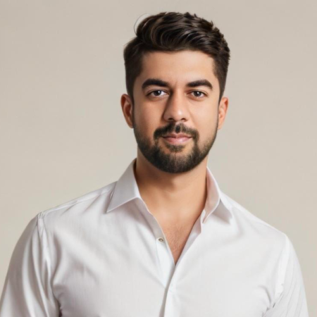 Preetham is standing, with his torso upwards being displayed. He is wearing a white shirt.