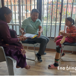 3 people sat in chairs talking.