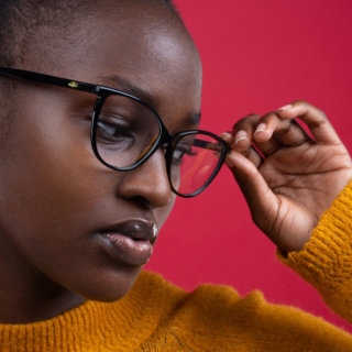 Image of young women - wearing fashion led eye glasses - in a bright jumper